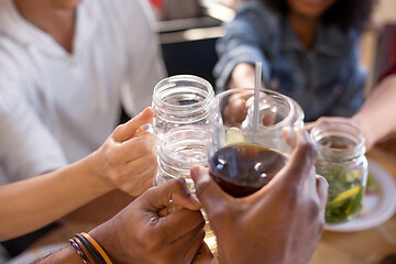 Image showing friends clinking glasses at bar or restaurant