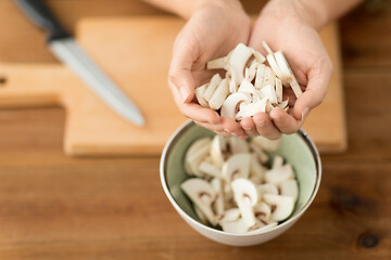 Image showing close up of woman holding chopped champignons