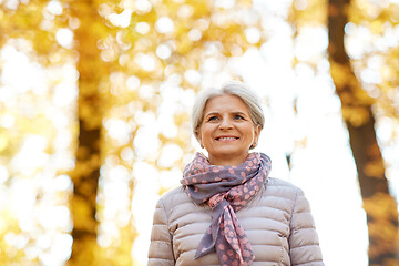 Image showing portrait of happy senior woman at autumn park