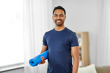 Image showing smiling indian man with exercise mat at home