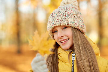 Image showing portrait of girl with maple leaf at autumn park