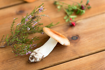 Image showing russule mushroom with heather on wooden background