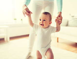 Image showing happy baby learning to walk with mother help