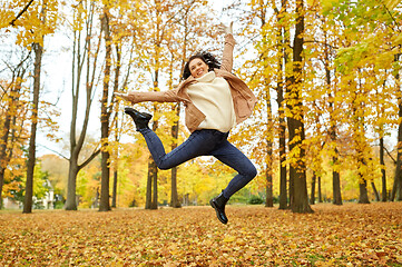 Image showing beautiful happy young woman in autumn park