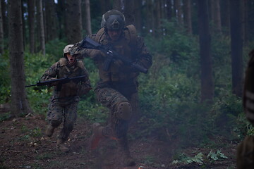 Image showing Soldier in Action at Night jumping over fire