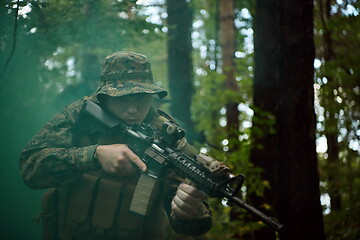 Image showing soldier in action aiming  on weapon  laser sight optics