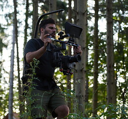 Image showing Videographer Taking Action Shoot of Soldiers in Action