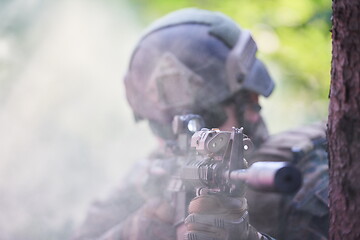 Image showing soldier in action aiming  on weapon  laser sight optics