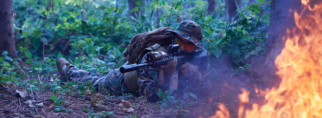 Image showing soldier in action aiming  on weapon  laser sight optics