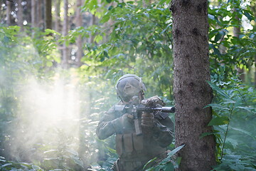 Image showing soldier in action aiming  on weapon  laser sight optics