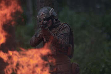 Image showing soldier in action aiming  on weapon  laser sight optics