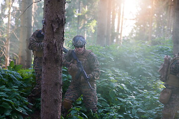 Image showing soldier in action aiming  on laser sight optics