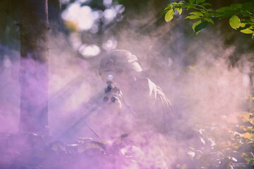 Image showing soldier in action aiming  on weapon  laser sight optics