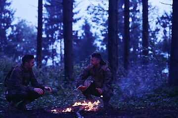 Image showing soldiers resting by fire in forest