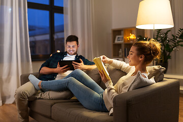 Image showing couple with tablet computer and book at home