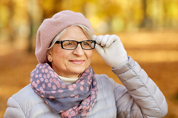 Image showing portrait of happy senior woman at autumn park