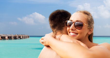 Image showing happy couple hugging on summer beach
