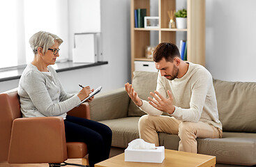 Image showing senior woman psychologist and sad man patient