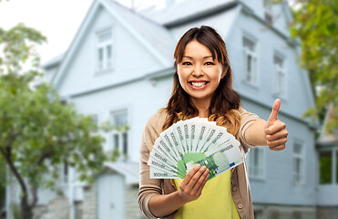 Image showing asian woman with euro money showing thumbs up