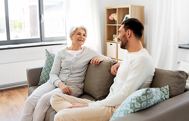 Image showing senior mother talking to adult son at home