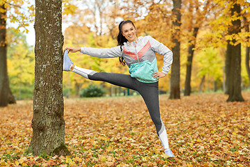 Image showing young woman doing sports at autumn park