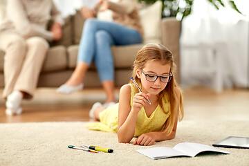 Image showing student girl writing to notebook at home