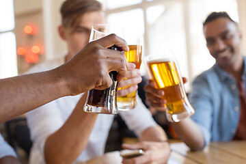 Image showing happy male friends drinking beer at bar or pub