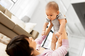 Image showing happy young mother with little baby son at home