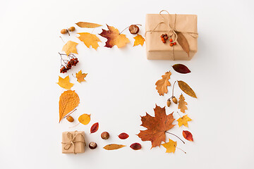 Image showing frame of gifts, autumn leaves and rowanberry