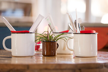 Image showing close up of cups with cutlery on restaurant table