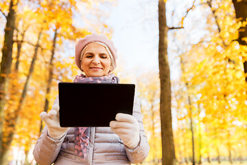 Image showing senior woman with tablet pc at summer park