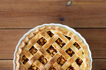 Image showing close up of apple pie in mold on wooden table