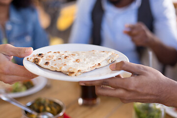 Image showing international friends eating at restaurant