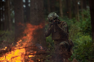 Image showing soldier in action aiming  on weapon  laser sight optics