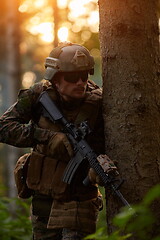 Image showing soldier in action aiming  on weapon  laser sight optics