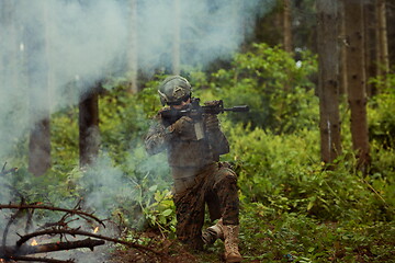 Image showing soldier in action aiming  on weapon  laser sight optics