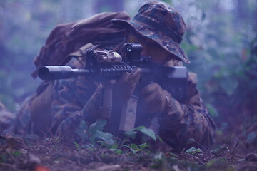 Image showing soldier in action aiming  on weapon  laser sight optics