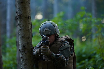 Image showing soldier in action aiming  on weapon  laser sight optics