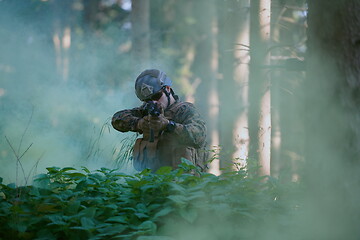 Image showing soldier in action aiming  on laser sight optics