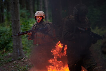 Image showing Soldier in Action at Night jumping over fire