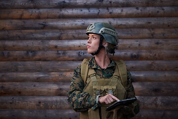 Image showing woman soldier using tablet computer