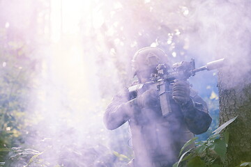 Image showing soldier in action aiming  on laser sight optics