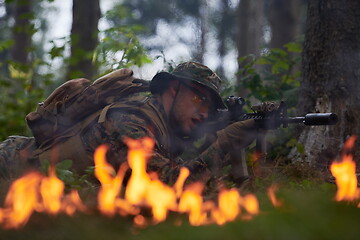 Image showing soldier in action aiming  on weapon  laser sight optics