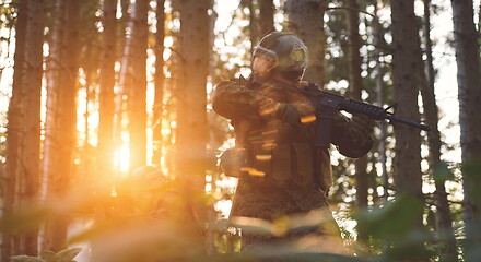 Image showing soldier in action aiming  on weapon  laser sight optics