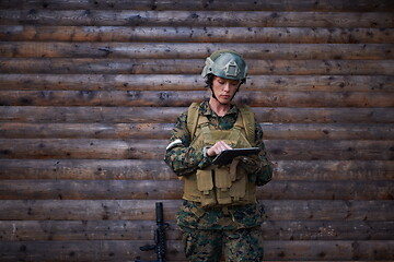 Image showing woman soldier using tablet computer