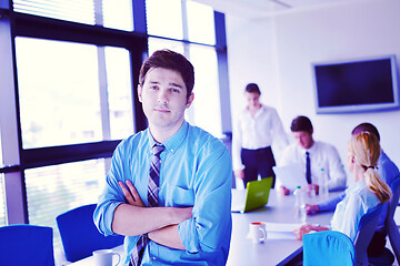 Image showing business man  on a meeting in offce with colleagues in backgroun