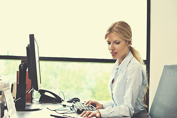 Image showing business woman working on her desk in an office