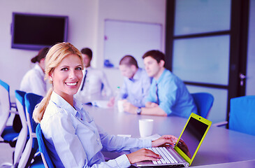 Image showing business woman with her staff in background at office