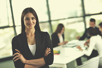 Image showing business woman with her staff in background at office