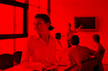 Image showing business woman with her staff in background at office